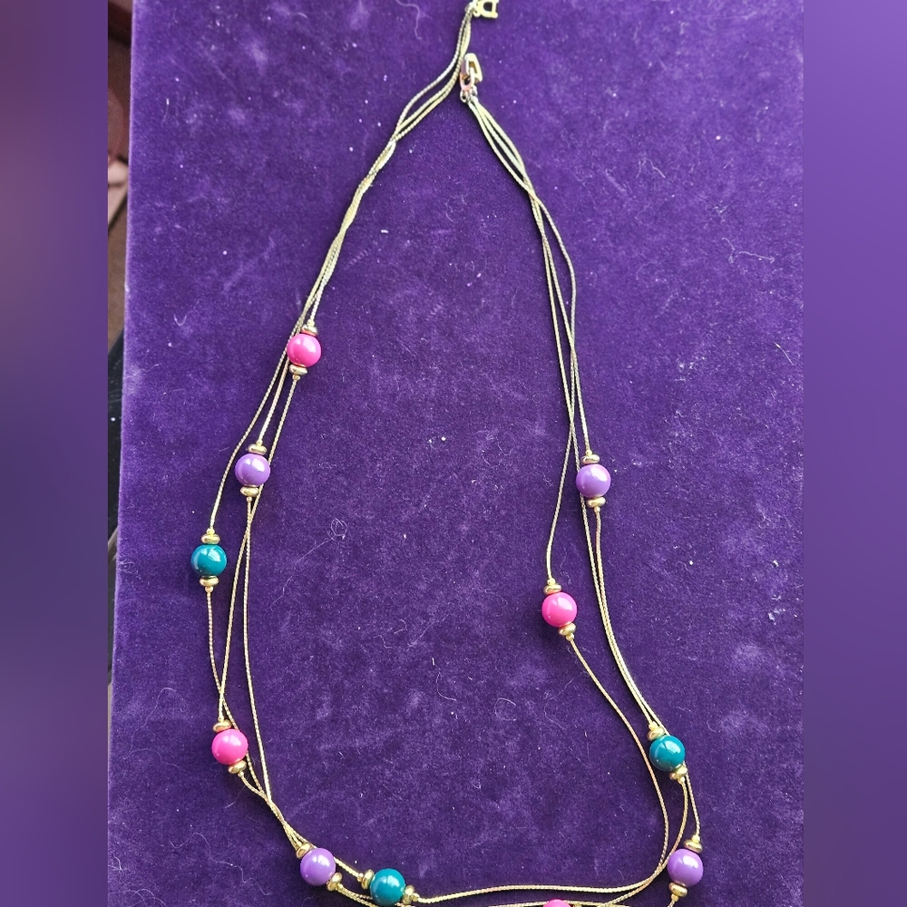3-strand gold-tone chain necklace with multi-colored beads.